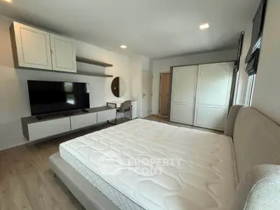 Spacious bedroom with modern furnishings and ample storage space