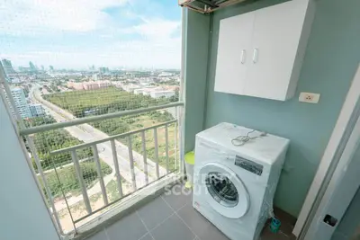 High-rise balcony with washing machine and stunning city view