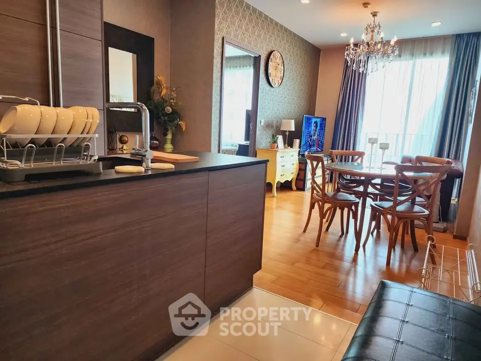 Stylish open-plan kitchen and dining area with elegant decor and natural light.