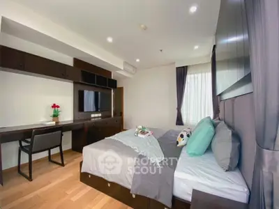 Spacious modern bedroom with elegant decor and natural light