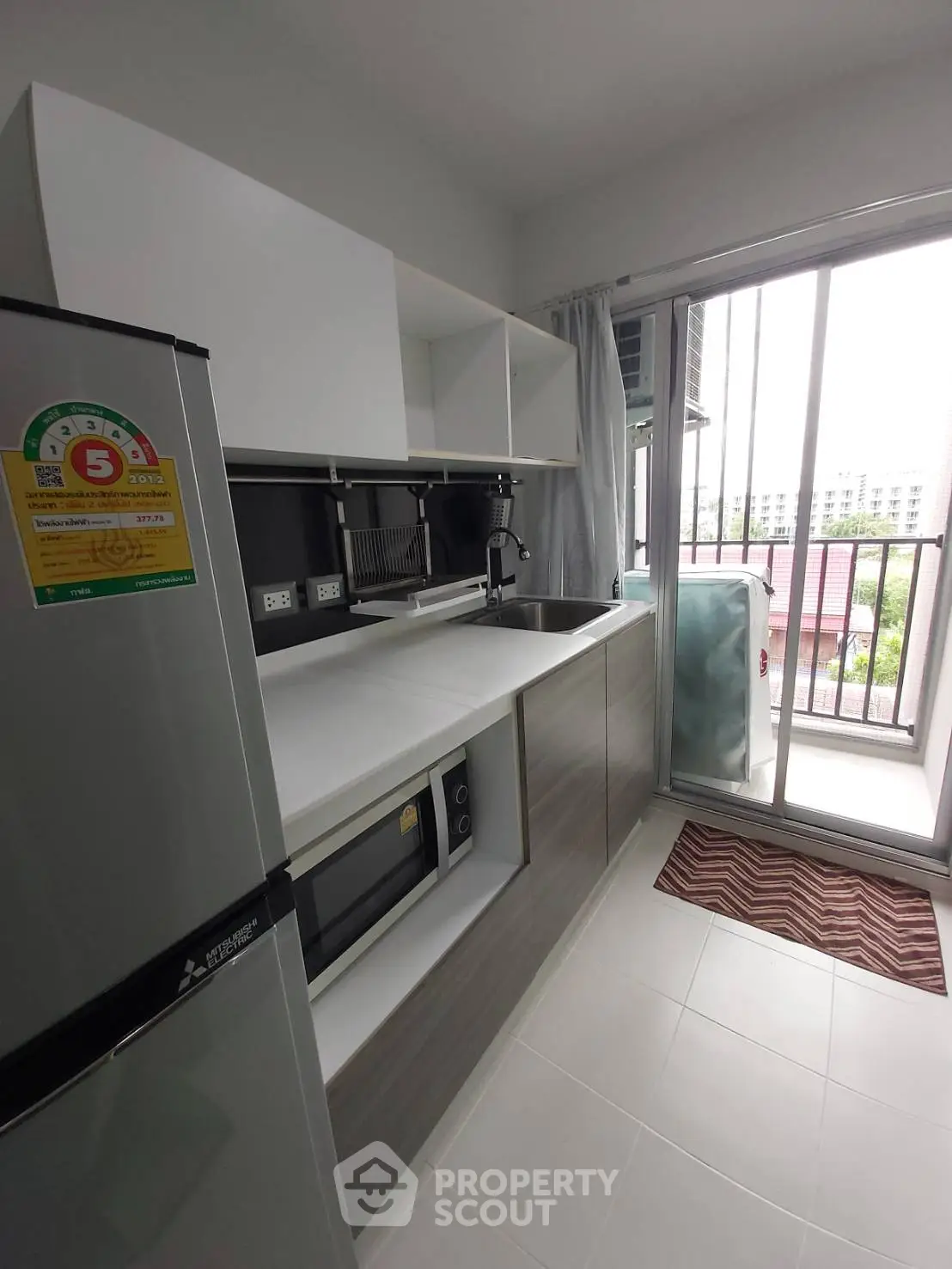 Modern kitchen with sleek design and balcony view in a stylish apartment