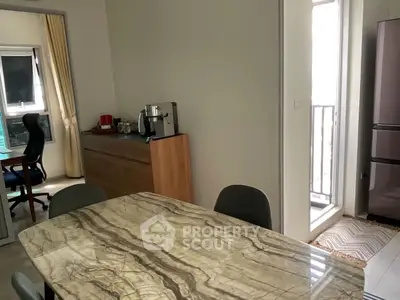 Modern dining area with marble table and balcony access