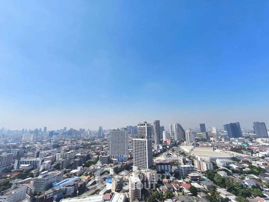 Stunning panoramic cityscape view showcasing urban skyline under clear blue sky.