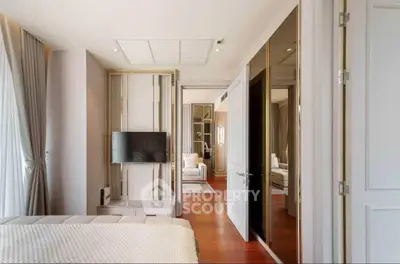 Elegant bedroom with en-suite bathroom, featuring hardwood floors, modern furnishings, and a seamless transition to a luxurious living area.