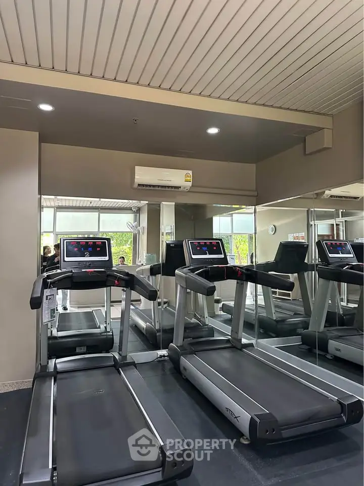 Modern gym with treadmills and mirrors in a sleek fitness center
