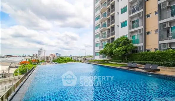 Luxurious high-rise apartment with stunning infinity pool and city view.