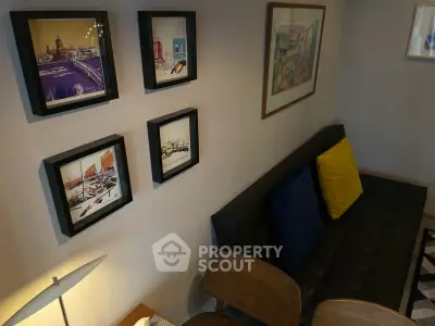 Stylish living room with modern decor and framed artwork on the wall.