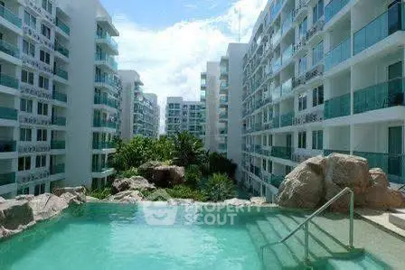 Luxurious residential complex with stunning pool and modern architecture.