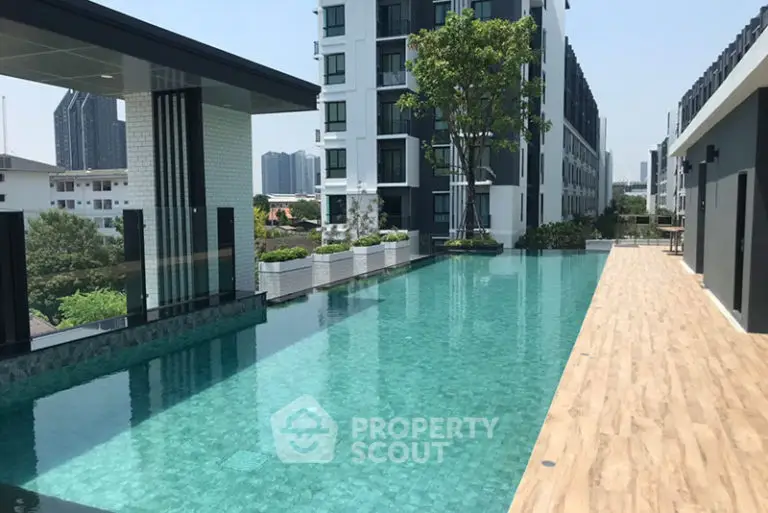 Luxurious rooftop pool with stunning city views in modern apartment complex.