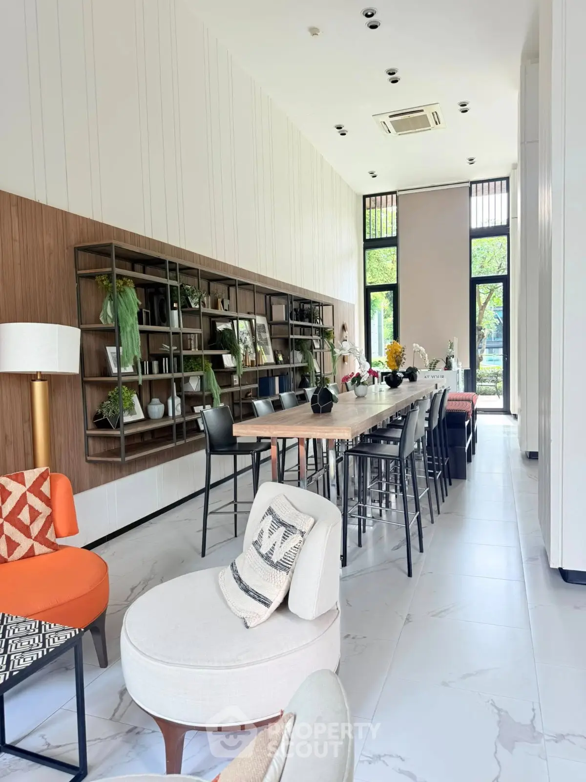 Spacious modern living room with elegant decor and large windows offering natural light.