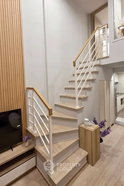 Modern duplex interior with stylish staircase and wooden accents