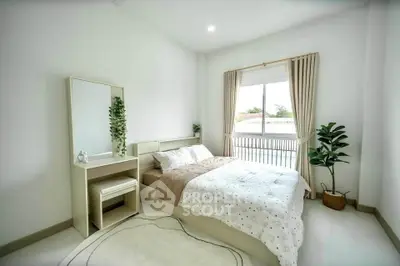 Bright and cozy bedroom with modern decor and large window view.