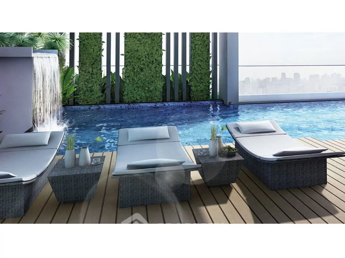 Luxurious rooftop pool with stylish loungers and city skyline view, perfect for relaxation and entertainment.
