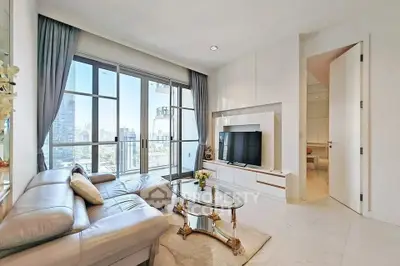 Luxurious living room with city view, elegant decor, and modern furnishings in a high-rise apartment.