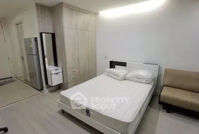 Modern bedroom with sleek design, featuring a comfortable bed, built-in wardrobe, and stylish decor.