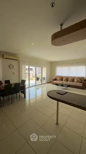 Spacious living room with modern decor and large windows for natural light.