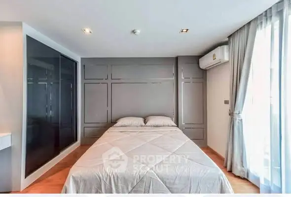 Modern bedroom with sleek design and ample natural light