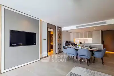 Modern open-plan living and dining area with sleek kitchen design and elegant furnishings.
