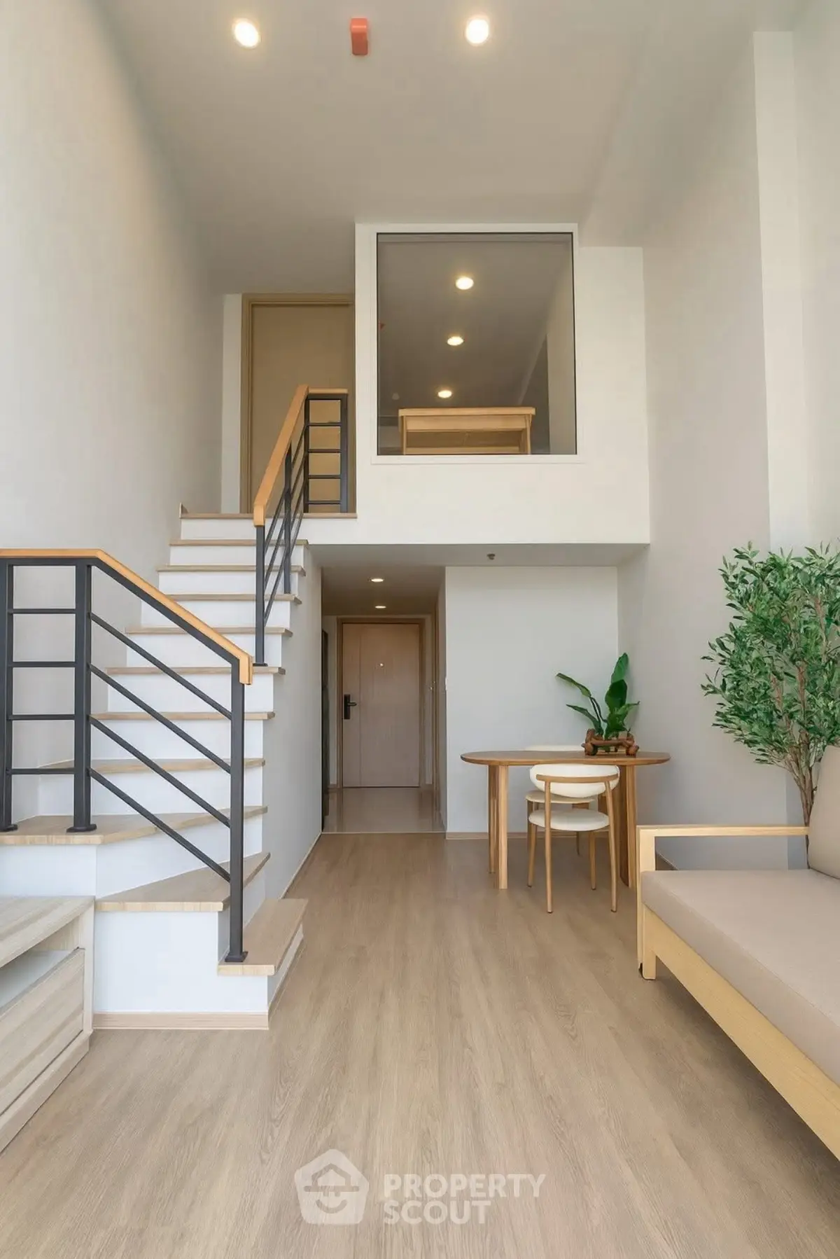 Modern duplex interior with stylish staircase and cozy seating area
