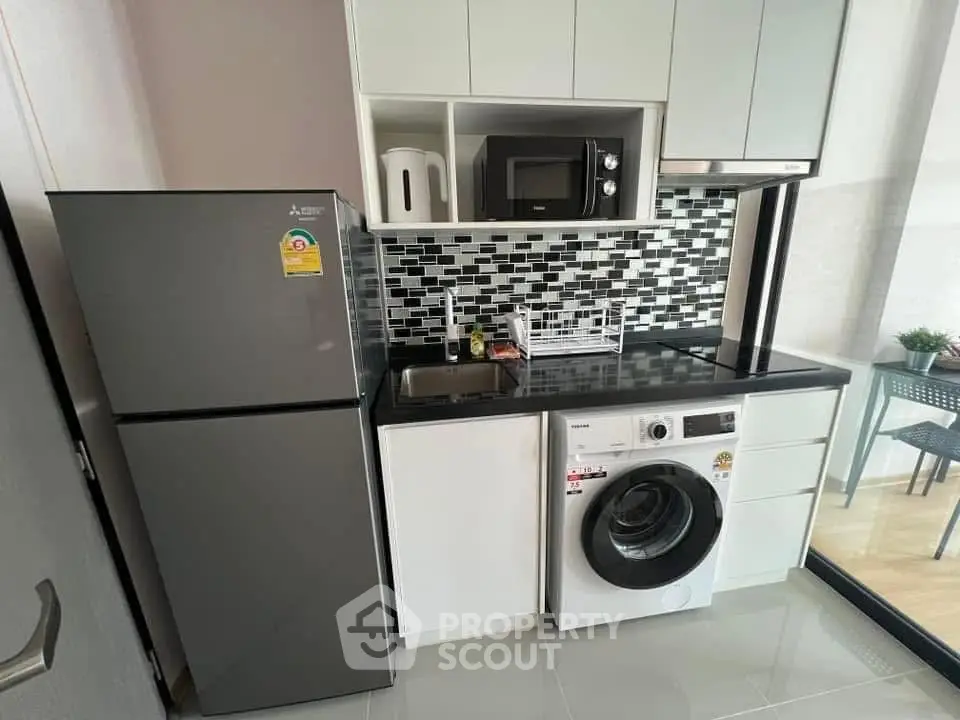 Modern compact kitchen with appliances and stylish backsplash