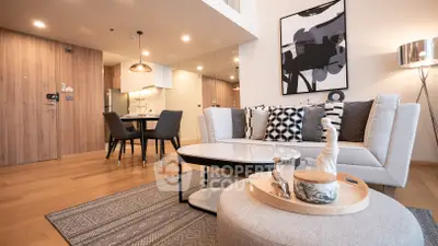 Modern living room with stylish decor and open kitchen layout in a contemporary apartment.