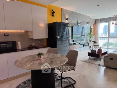 Modern living room with open kitchen, stylish decor, and city view.