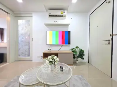 Modern living room with air conditioning and flat-screen TV, stylish decor and cozy ambiance.