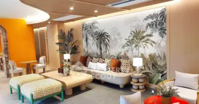 Luxurious living room with stylish decor and tropical-themed wall art, perfect for modern living.