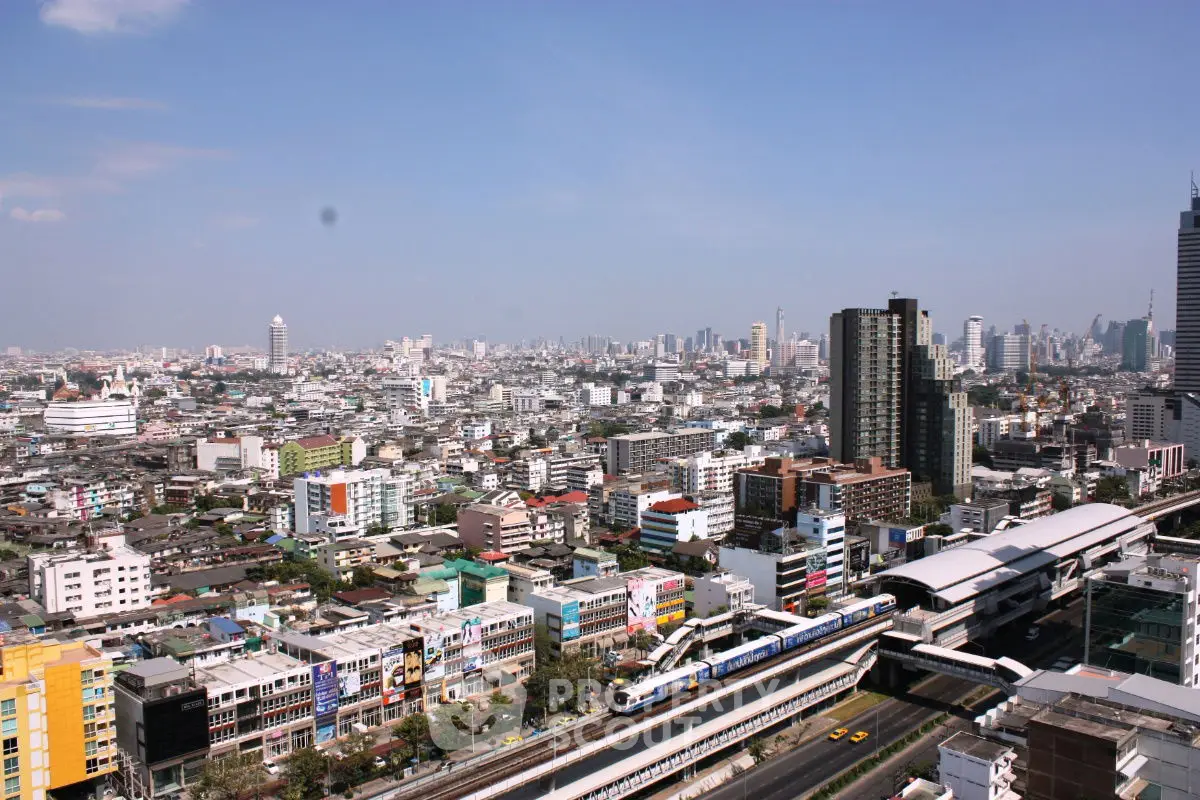 Stunning cityscape view showcasing urban skyline and bustling train station.