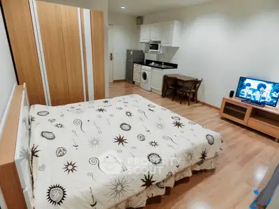 Cozy studio apartment with modern furnishings and compact kitchen