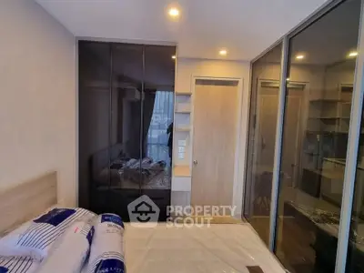 Modern bedroom with sleek glass wardrobes and cozy lighting