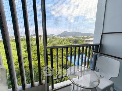 Charming balcony with stunning mountain view and modern seating area.