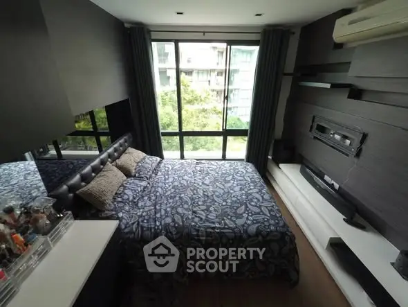 Modern bedroom with large window and stylish decor in urban apartment