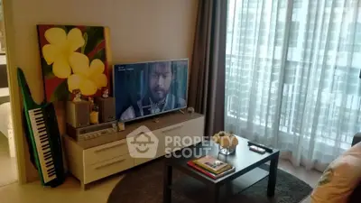 Modern living room with TV, stylish decor, and large window with city view.