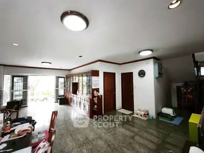 Spacious living room with elegant wooden cabinets and ample natural light