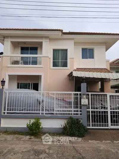 Charming two-story house with a covered carport and modern balcony in a serene neighborhood.