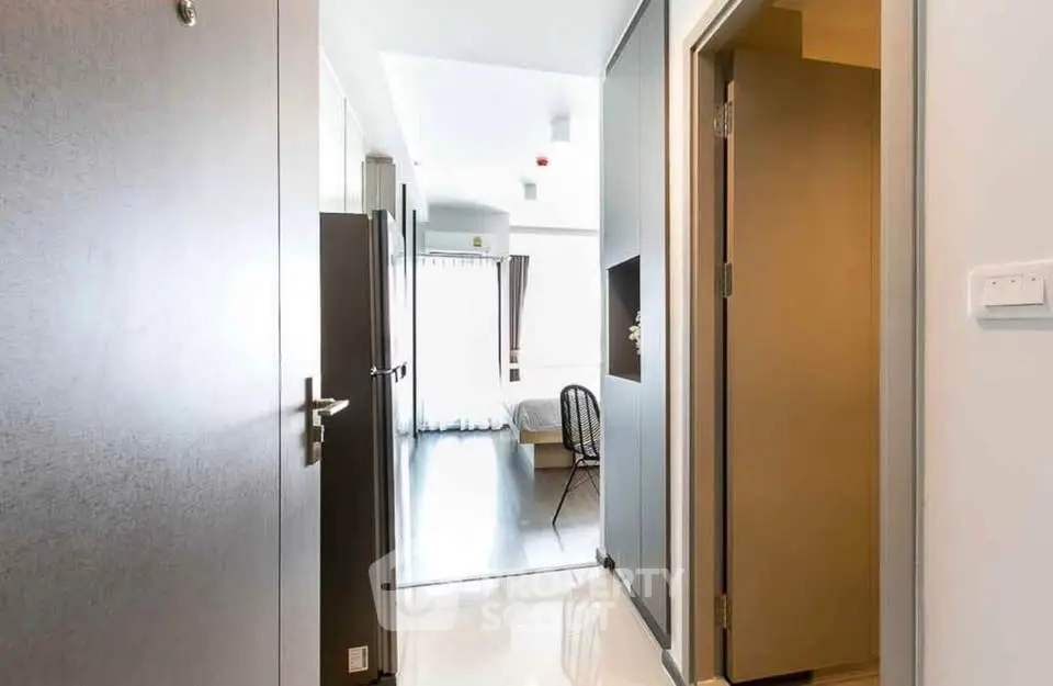 Bright and modern apartment entrance leading to a cozy living space with natural light.