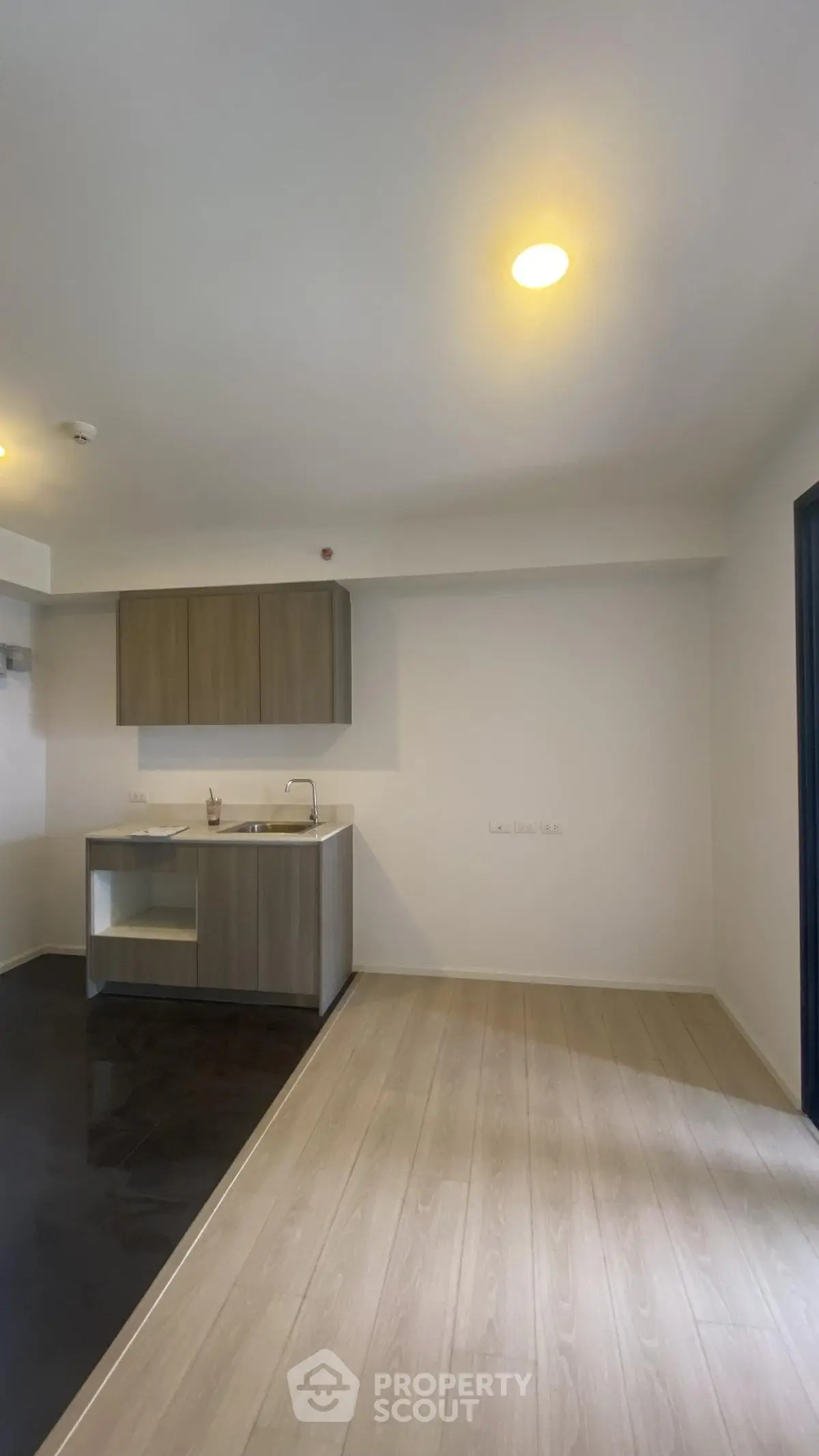 Modern kitchen with sleek cabinetry and open layout in a contemporary apartment.