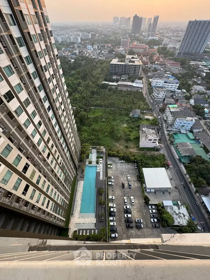 Stunning high-rise building view with pool and cityscape at sunset