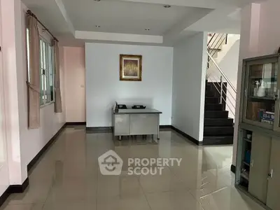 Spacious interior with modern staircase and sleek tiled flooring