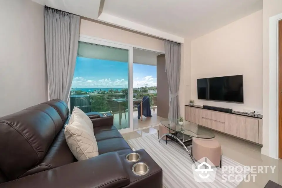 Modern living room with leather sofa and stunning balcony view