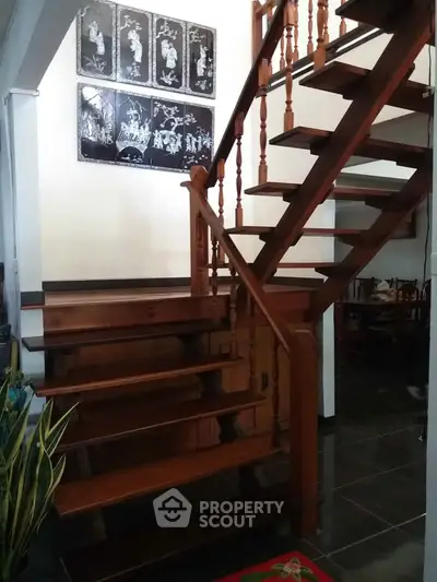 Charming wooden staircase in a cozy home interior with elegant decor.