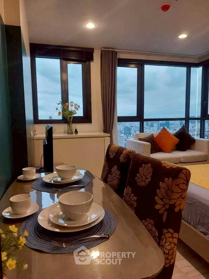 Chic modern living room with stunning city view and elegant dining setup