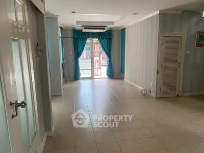 Spacious unfurnished living room with tiled floors and large window for natural light.