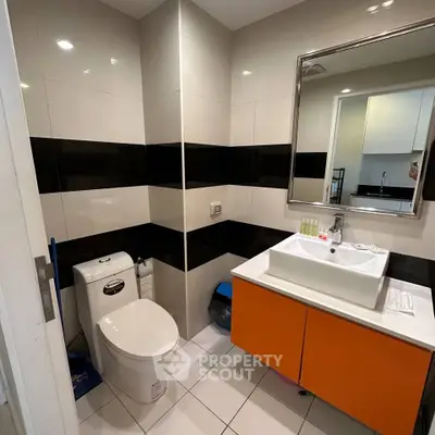 Modern bathroom with sleek design featuring a stylish sink and contemporary fixtures.