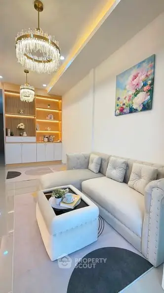 Luxurious living room with elegant chandelier and plush sofa in modern apartment