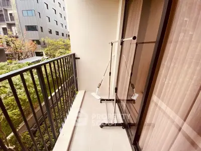 Charming balcony with lush garden view in modern apartment complex.