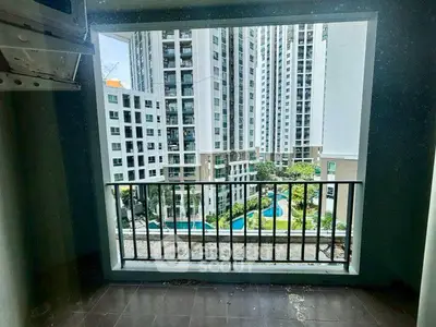 High-rise apartment balcony with stunning cityscape and pool view