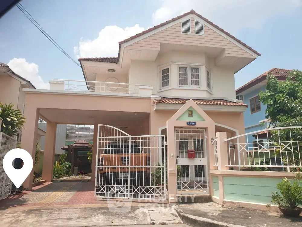 Charming two-story house with gated entrance and spacious driveway in a serene neighborhood.