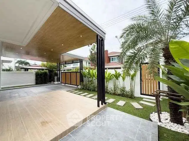 Modern home exterior with spacious patio and lush garden